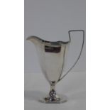 A Victorian silver geometric design silver cream jug on octagonal base with linear detailing to