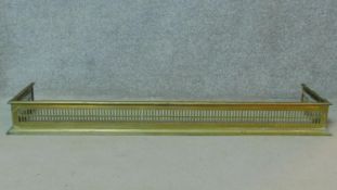 An early 19th century pierced brass fire fender. H.14 W.134 D.30cm