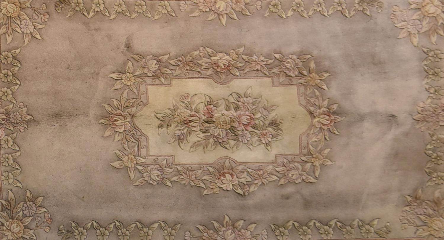 A Chinese woollen carpet with allover floral decoration on a mink ground.. L.284x184cm - Image 2 of 4