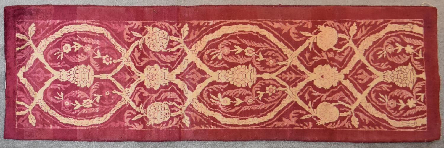An Ottoman runner with allover scrolling vine decoration contained within a plain border. L.240x80cm