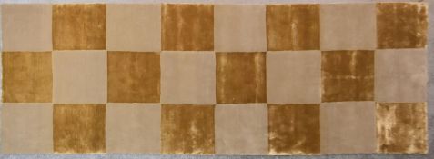 A silk and wool runner with gold and beige chequerboard design. L.300x110cm