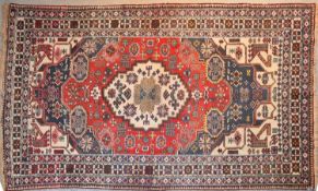 A Turkish rug with central double pendant medallion with repeating stylised floral motifs on a