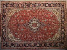 A Persian Tabriz carpet with floral central double pendant medallion surrounded by spandrels on a