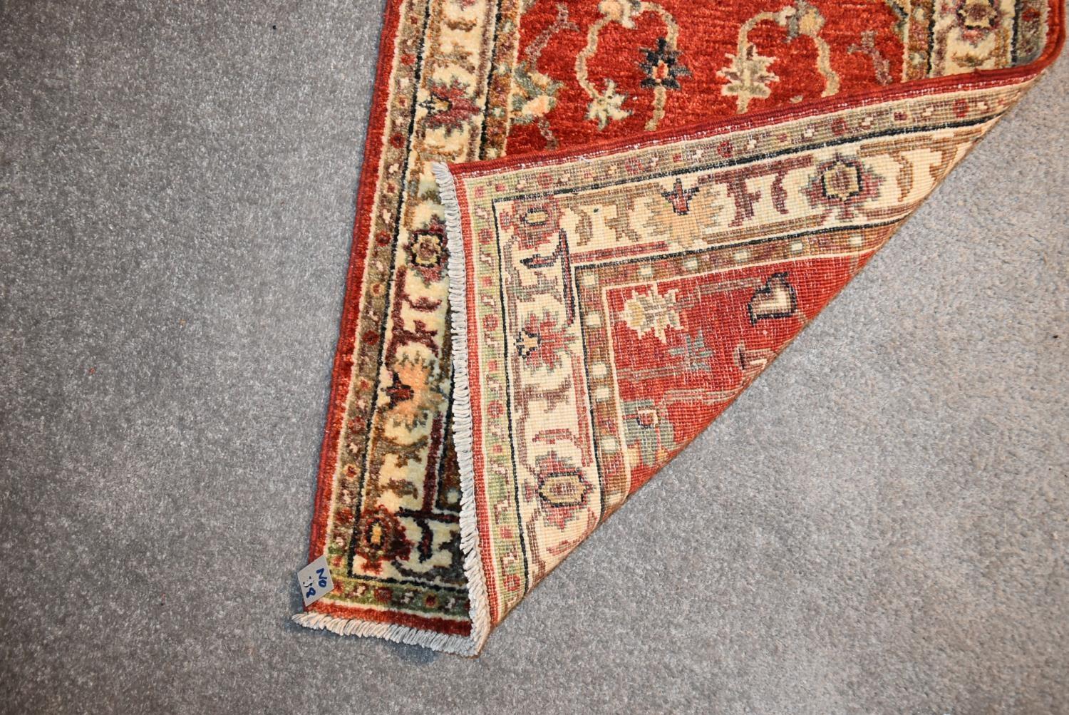 A Ziegler runner with allover scrolling floral design on a deep red field. L.335x60cm - Image 4 of 4