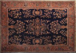 A Turkish Carpet with floral motifs to the central field within maroon foliate and flowerhead