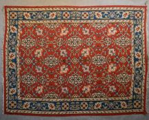 A Kilim with repeating scrolling floral design surrounded by an azure flowerhead border. L.290x226cm