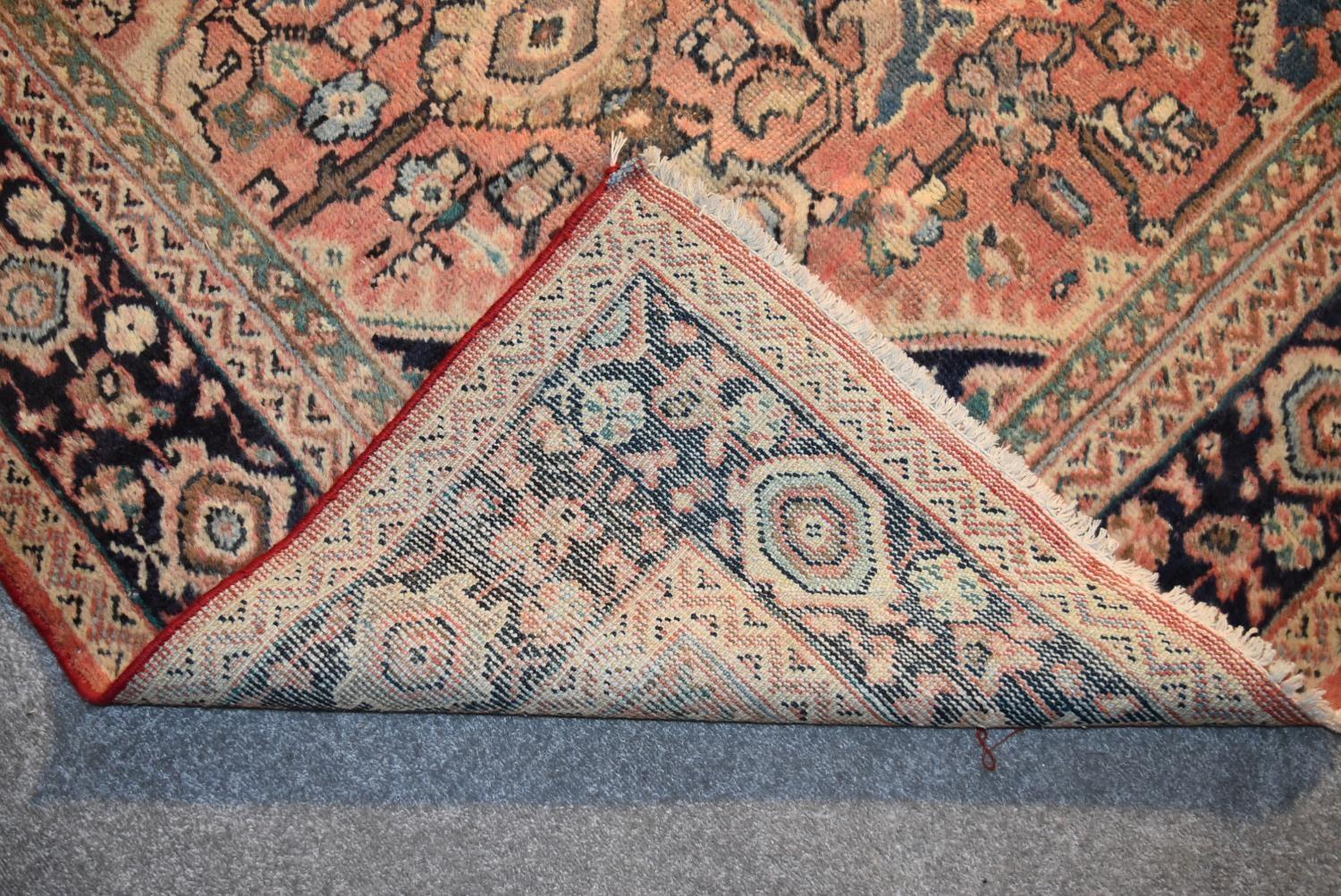 A Persian Mahal rug with repeating floral decoration and spandrels on a blush ground contained - Image 4 of 4