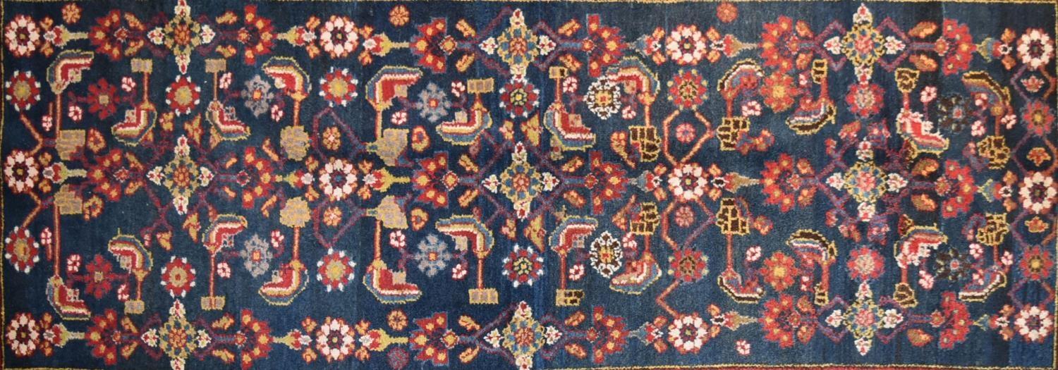 A Persian rug with complete floral and petal motifs on a midnight blue ground contained within - Image 2 of 4