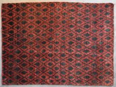 A contemporary rug with geometric diamond pattern and motifs on a burgundy field. L.220x155cm