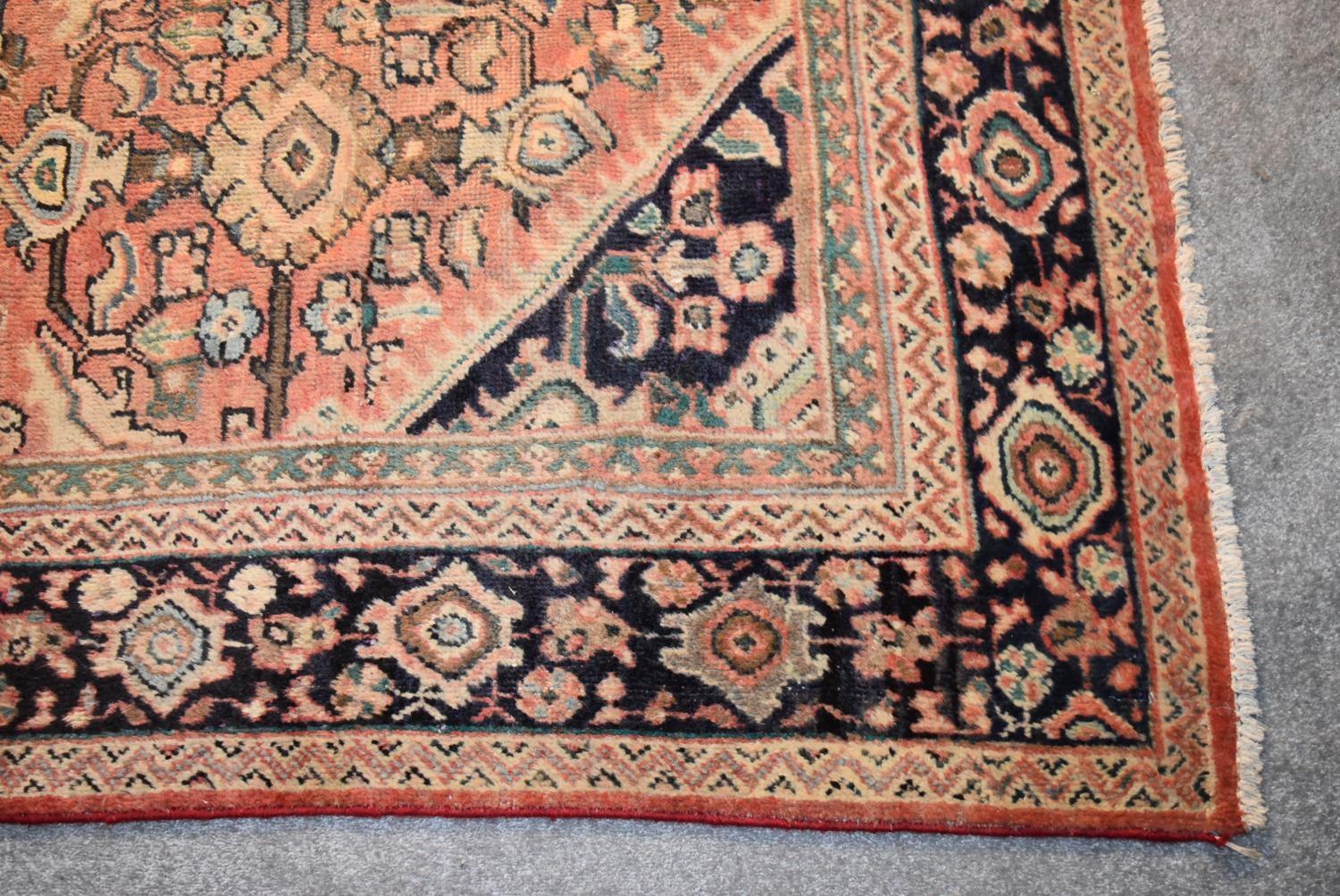 A Persian Mahal rug with repeating floral decoration and spandrels on a blush ground contained - Image 3 of 4
