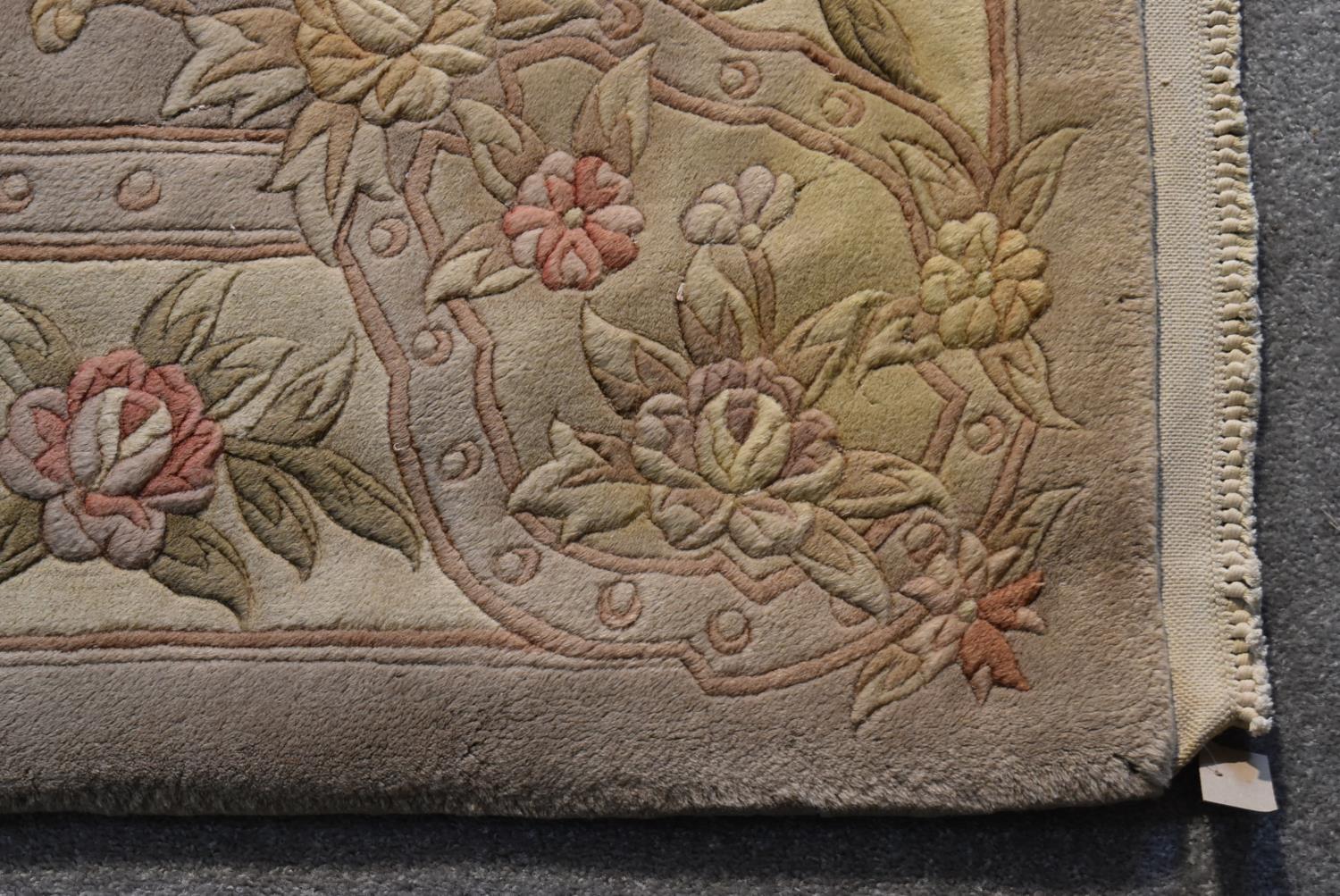 A Chinese woollen carpet with allover floral decoration on a mink ground.. L.284x184cm - Image 3 of 4