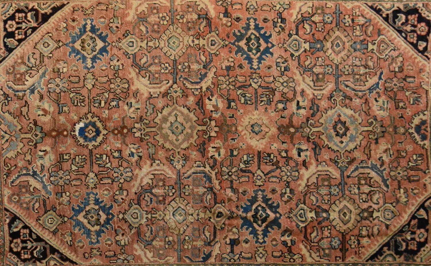 A Persian Mahal rug with repeating floral decoration and spandrels on a blush ground contained - Image 2 of 4