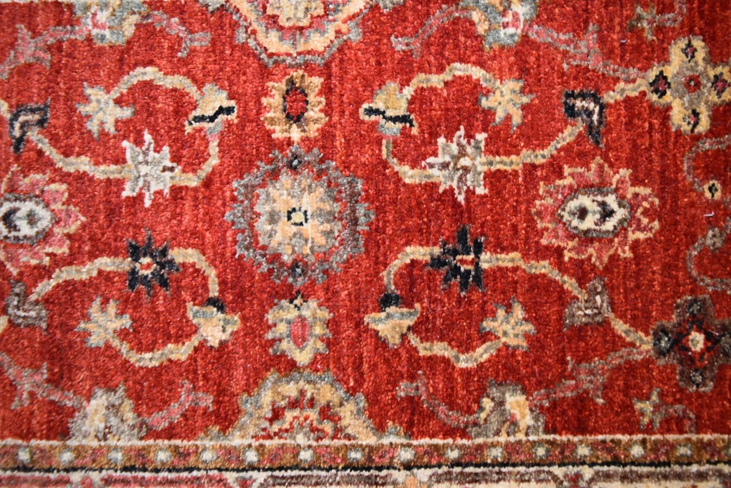 A Ziegler runner with allover scrolling floral design on a deep red field. L.335x60cm - Image 2 of 4