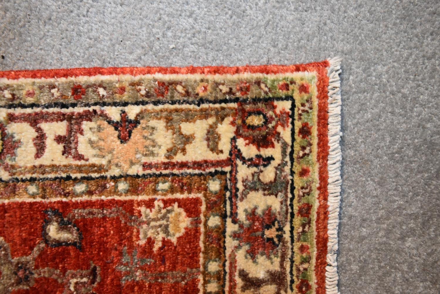 A Ziegler runner with allover scrolling floral design on a deep red field. L.335x60cm - Image 3 of 4