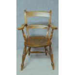 A 19th century country style open armchair with elm seat on turned stretchered supports. H.89cm
