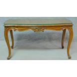 A Louis XV style burr walnut low coffee table with plate glass top on carved cabriole supports. H.52