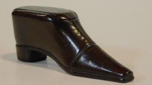 An antique wooden treen snuff box in the form of a heeled boot. Brass stud detailing to the boot