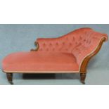 A Victorian carved mahogany framed chaise longue in deep buttoned blush velour upholstery raised