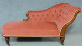 A Victorian carved mahogany framed chaise longue in deep buttoned blush velour upholstery raised