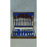 A oak cased six person canteen of silver plated cutlery by Frank Cobb and Co Sheffield. Missing four