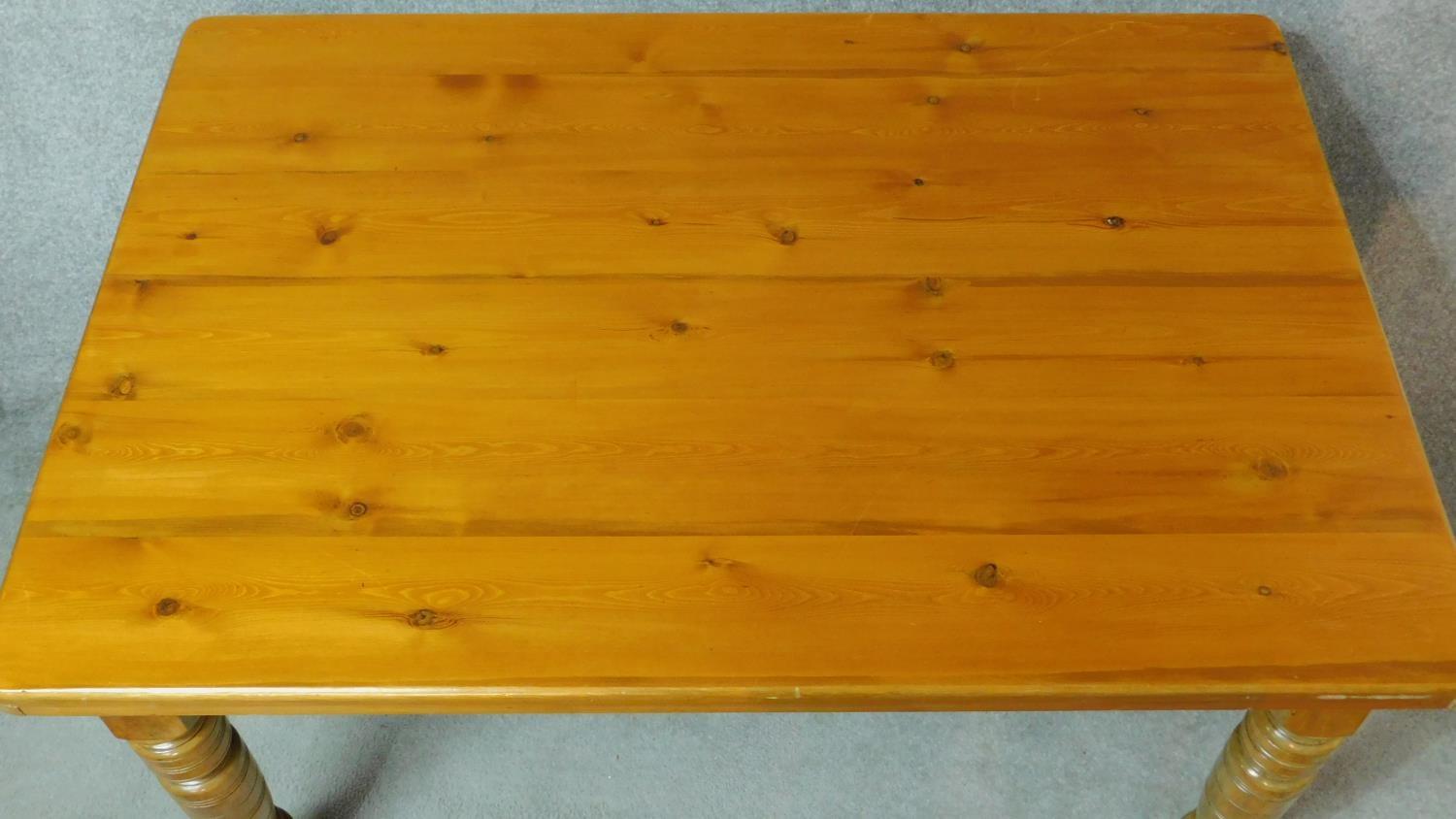 A late Victorian dining table with pitch pine top on turned tapering supports. H.73 W.137 D.94cm - Image 2 of 3