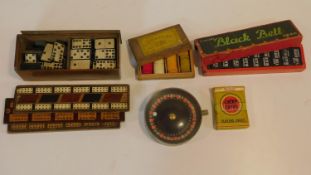 A collection of vintage and antique games. Including a miniature spring mechanism roulette wheel,