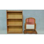 A mid 20th century teak open bookcase and a Victorian mahogany swing toilet mirror. H.91 W.61 D.18cm