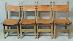 A set of four carved beech framed Continental style dining chairs with tan leather backs and