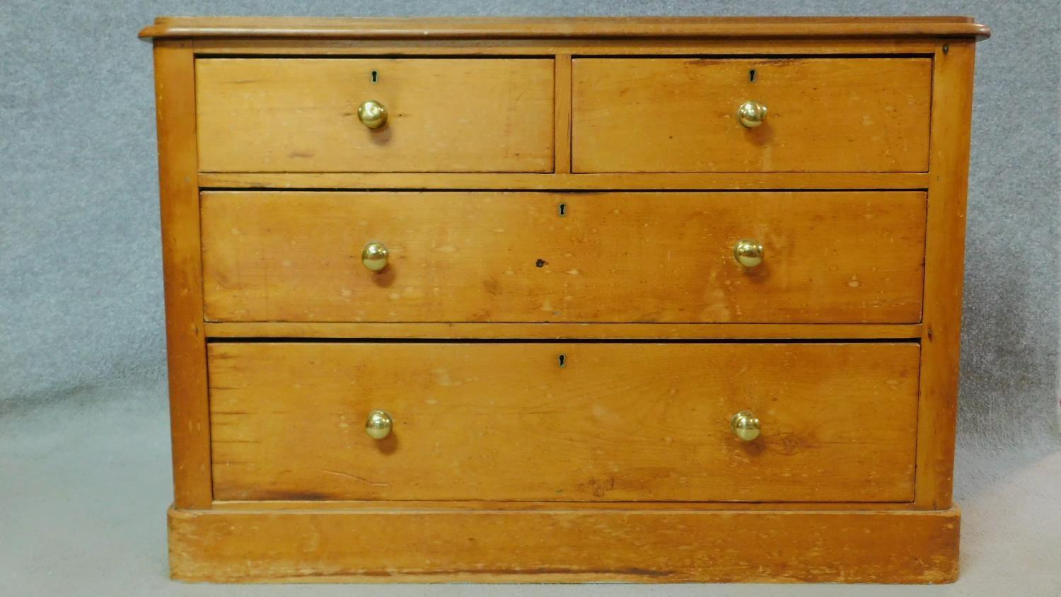 A Victorian pine chest of two short over two long drawers on plinth base. H.74 W.108 D.48cm