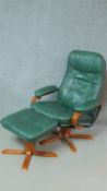 A vintage revolving armchair in sage green leather upholstery together with a matching footstool.