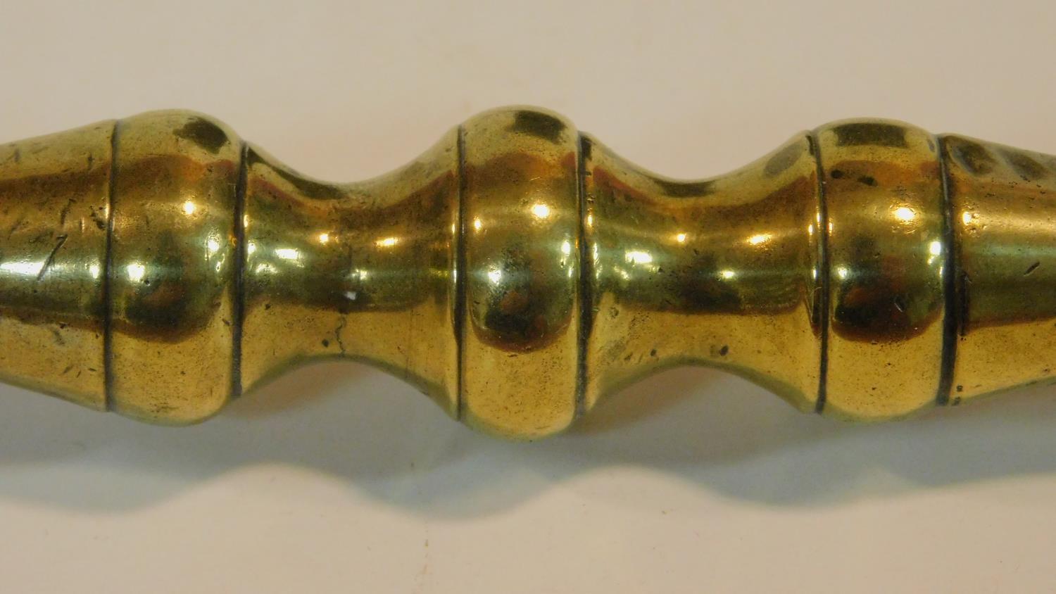 An antique bronze handled mortar and brass pestle. The handle has a textured design and the front of - Image 6 of 8