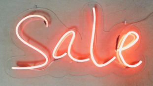 A neon tube wall mounted light up sign. (light doesnt stay on). H.60 W.110cm
