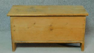 A 19th century pine plank coffer with hinged lidded top. H.41 W.80 D.34cm