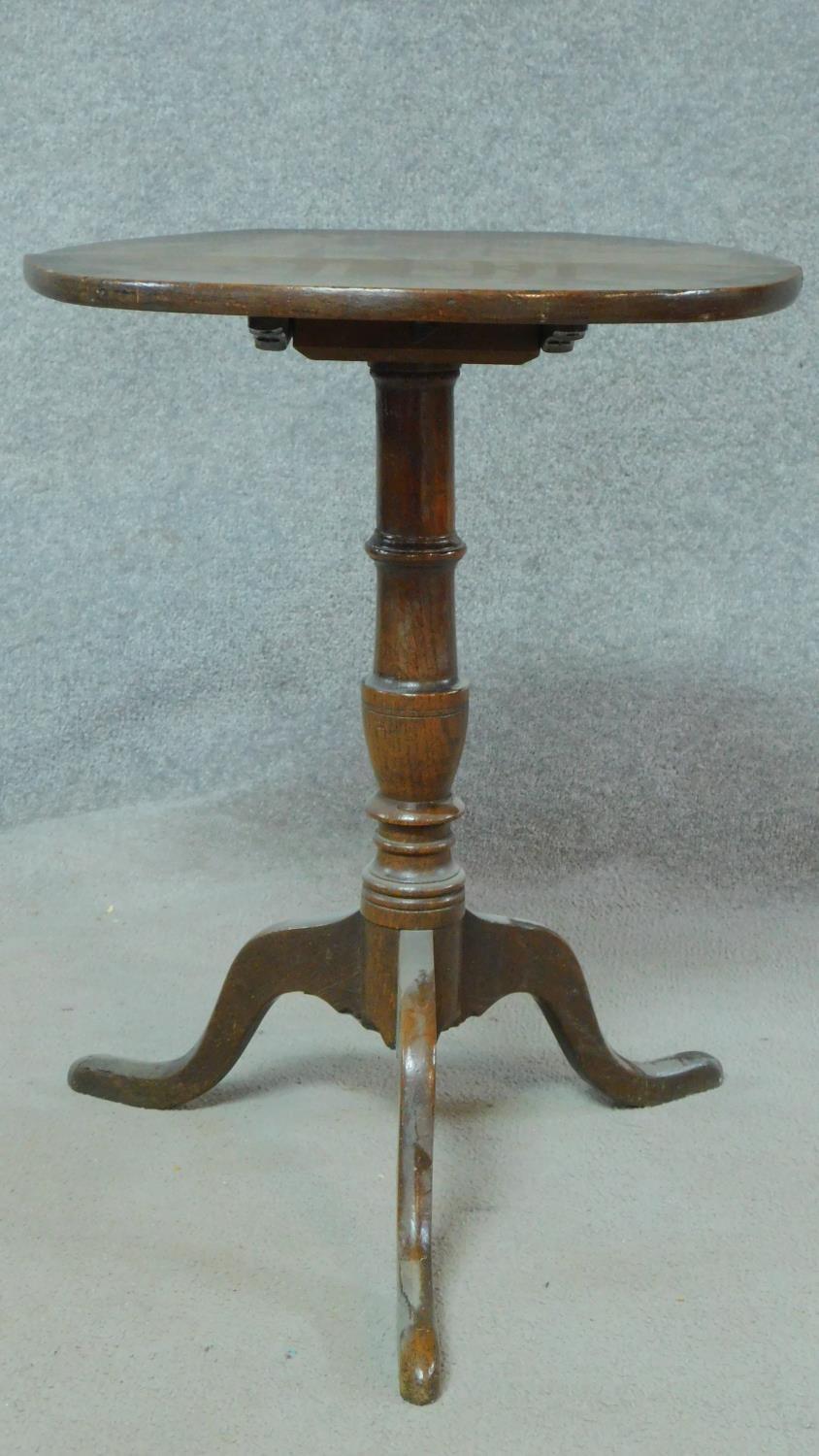 A Georgian oak tilt top occasional table on tripod pedestal base. H.64 W.49 D.45cm