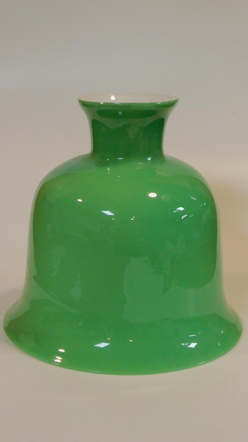 A vintage bell shaped opaque apple green blown glass ceiling pendant lampshade with white glass