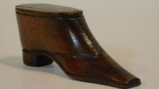 An antique wooden treen snuff box in the form of a heeled boot. Brass stud detailing to the top