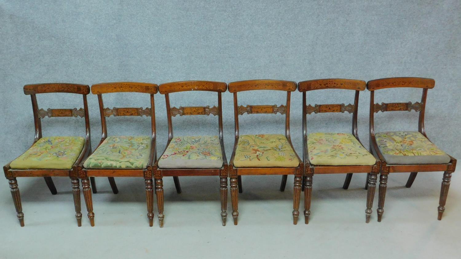 A set of six George IV faux rosewood and satinwood inlaid bar back dining chairs with drop in