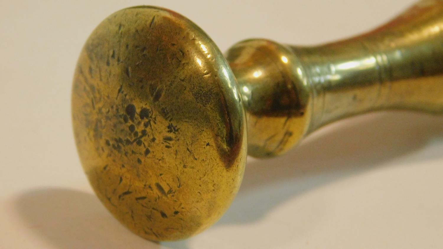 An antique bronze handled mortar and brass pestle. The handle has a textured design and the front of - Image 7 of 8