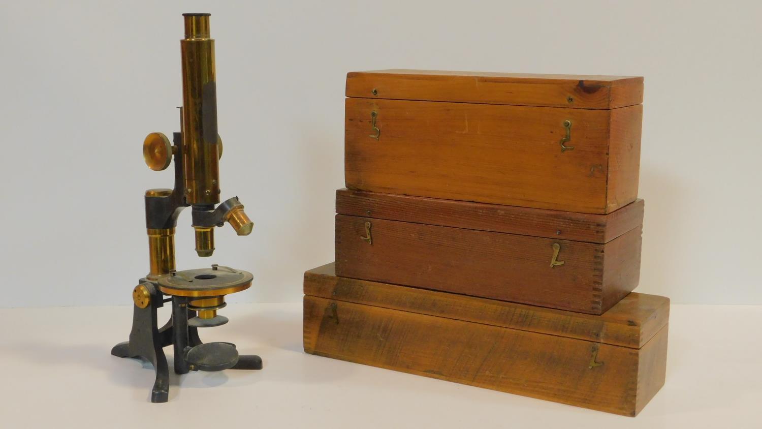 An Eclipse Ross of London lacquered brass microscope with Zeiss microscope eye piece. With three
