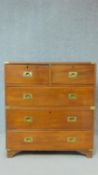 A 19th century two section teak brass bound military chest with two short over three long drawers on