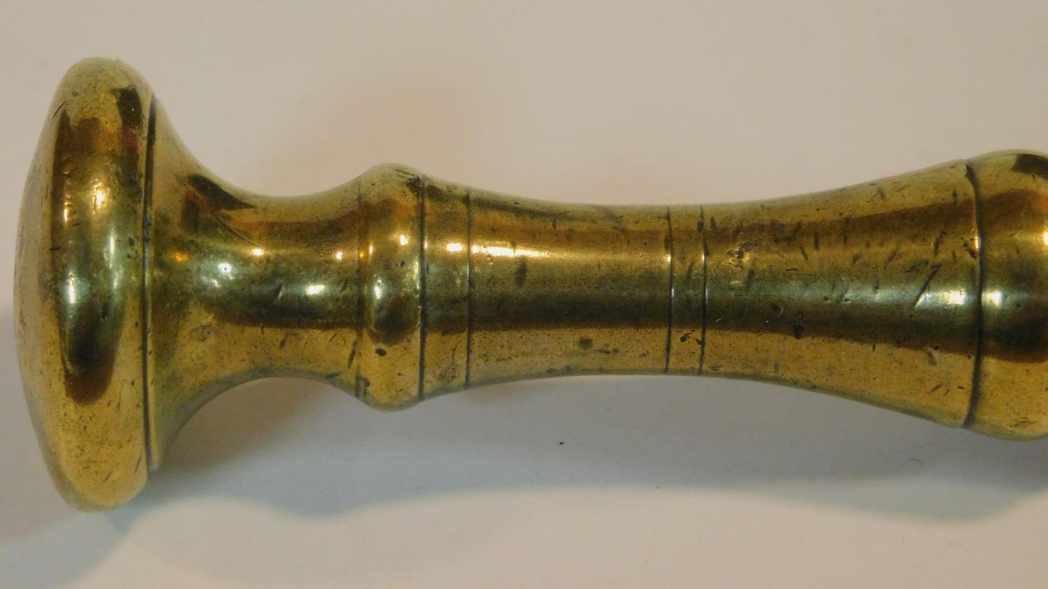 An antique bronze handled mortar and brass pestle. The handle has a textured design and the front of - Image 5 of 8