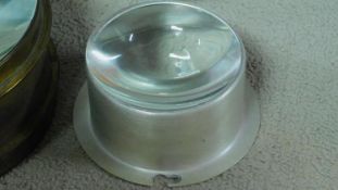 A collection of two vintage table map magnifiers, an aluminium cased lens and a large crystal