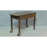 A 19th century oak side table with end drawer on square supports standing on large casters. H.67 W.