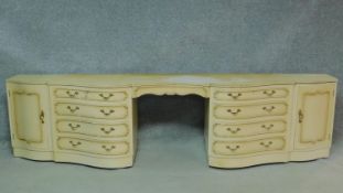 A mid century vintage cream and gilt sideboard or long dressing table fitted with kneehole section