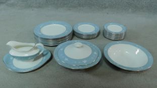 A Royal Doulton part dinner service in pale blue floral glaze to include nine dinner plates.