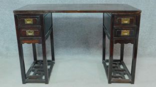 A 19th century Chinese teak three section pedestal desk fitted with two drawers to each side above