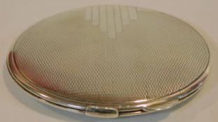 A sterling silver Art Deco circular compact mirror with engine turned decoration. Hallmarked: B&C