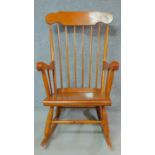 A 19th century style teak framed rocking chair. H.102cm