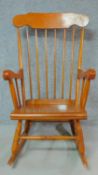 A 19th century style teak framed rocking chair. H.102cm