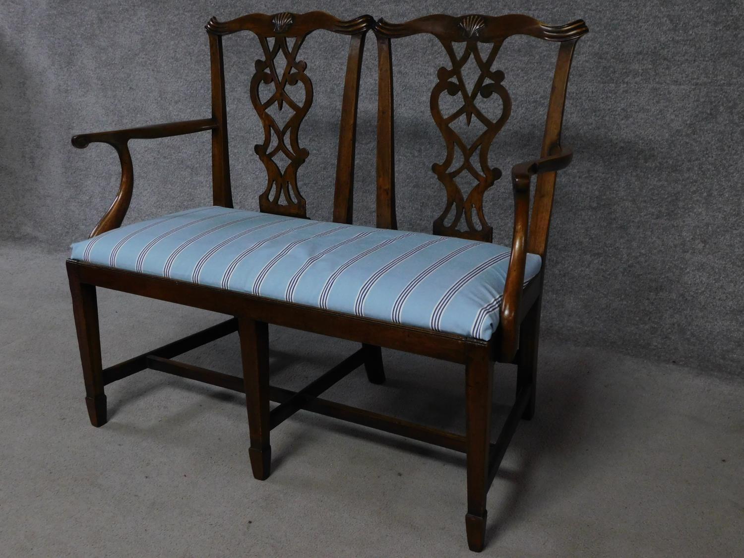 A George III Chippendale style mahogany double chair back settee with pierced splat and drop in seat